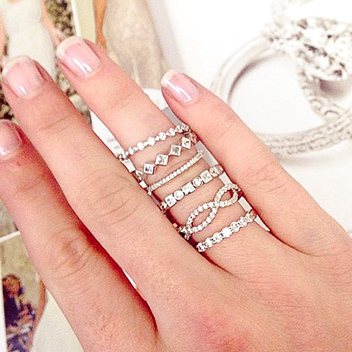 Finger with multiple diamond rings on it