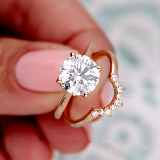 Macro photo of diamond ring held between 2 photos